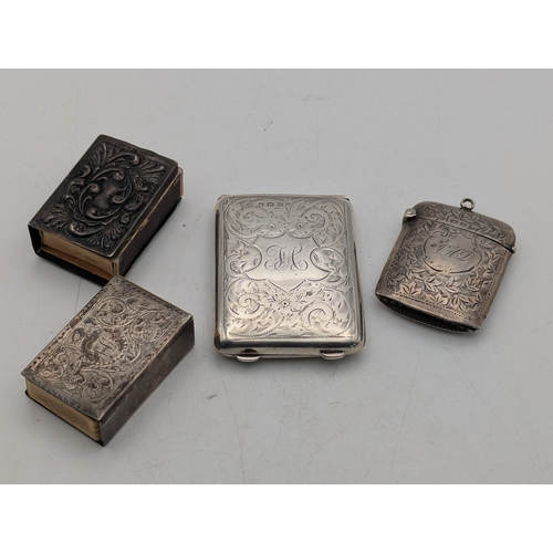 110 - A group of silver items to include a floral engraved match stick case, a vesta case and two matchbox... 