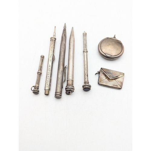 116 - A group of silver and white metal propelling pencils and others, together with a stamp holder and a ... 