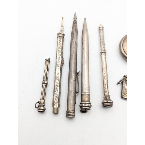 116 - A group of silver and white metal propelling pencils and others, together with a stamp holder and a ... 