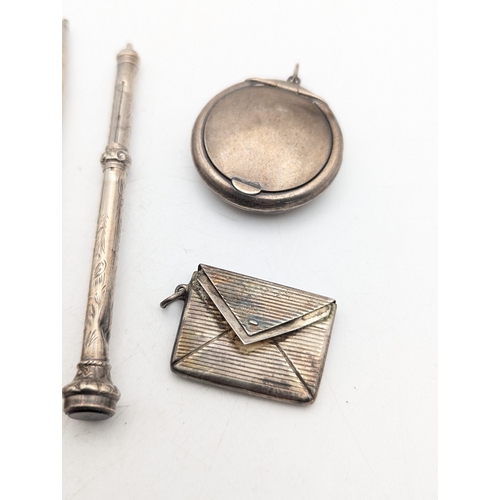 116 - A group of silver and white metal propelling pencils and others, together with a stamp holder and a ... 