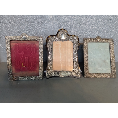 118 - Three silver fronted photo frames to include a floral embossed tortoiseshell example, together with ... 