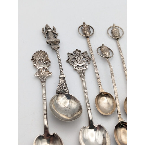 65 - A selection of white metal tea and coffee spoons to include tourist examples and others, total weigh... 