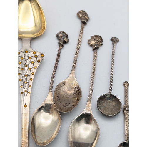 65 - A selection of white metal tea and coffee spoons to include tourist examples and others, total weigh... 