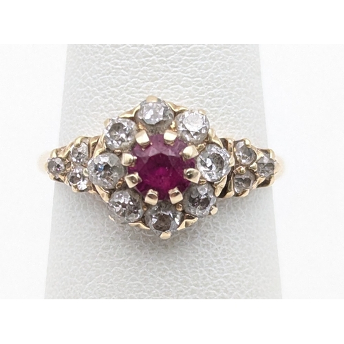 75 - A ruby and diamond 14ct yellow gold cluster ring, set with a central claw set ruby surrounded by dia... 