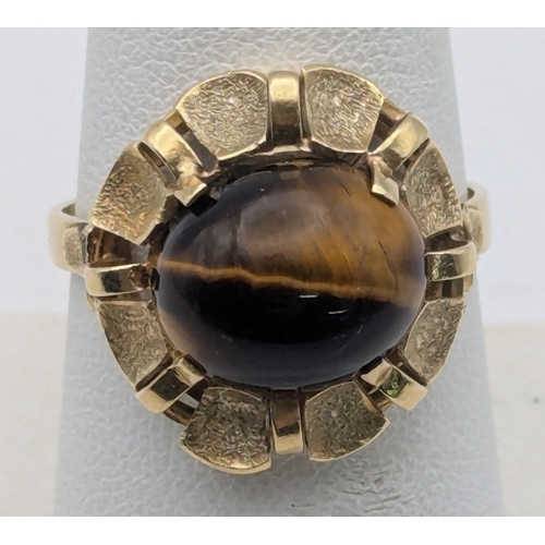 76 - A 14ct yellow gold and claw set Tiger's Eye ring stamped 585 size R, 4.2g Location:R2
If there is no... 
