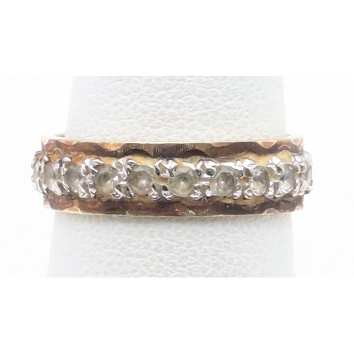 83 - A two-tone 9ct gold eternity ring set with three white stones possibly sapphires, size N 1/2, 3.9g
L... 