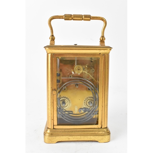 50 - A late 19th/early 20th century gilt brass repeater carriage clock, the white enamel dial with Roman ... 