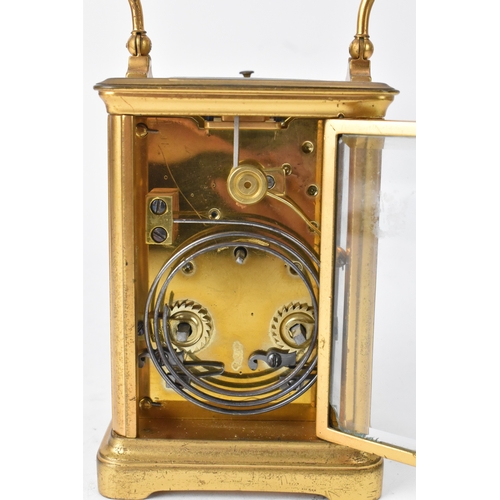 50 - A late 19th/early 20th century gilt brass repeater carriage clock, the white enamel dial with Roman ... 