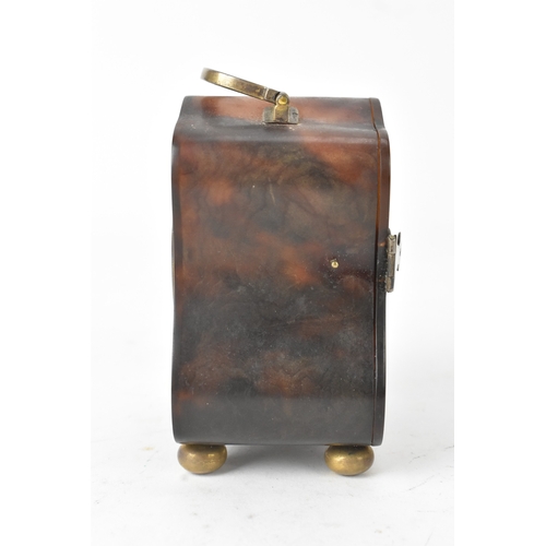 52 - An early 20th century tortoiseshell travel clock, having a silver swing handle hallmarked London 191... 