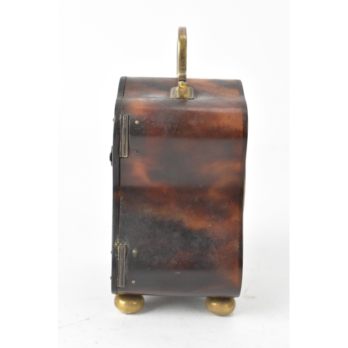 52 - An early 20th century tortoiseshell travel clock, having a silver swing handle hallmarked London 191... 