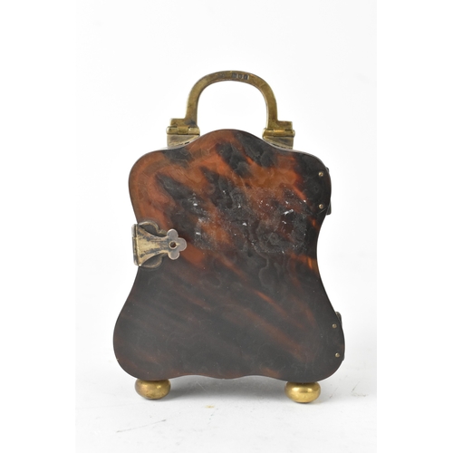 52 - An early 20th century tortoiseshell travel clock, having a silver swing handle hallmarked London 191... 