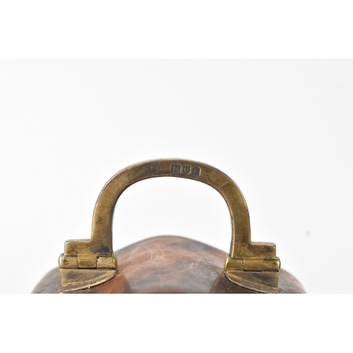 52 - An early 20th century tortoiseshell travel clock, having a silver swing handle hallmarked London 191... 