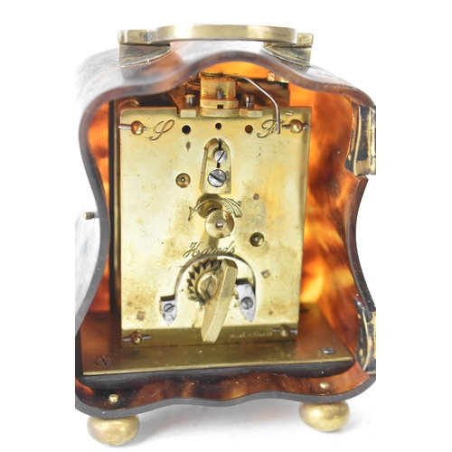 52 - An early 20th century tortoiseshell travel clock, having a silver swing handle hallmarked London 191... 