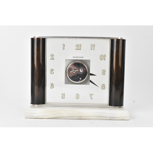 53 - An Art Deco Jaeger LeCoultre mystery clock, having a perspex and chrome case, the dial with Roman nu... 