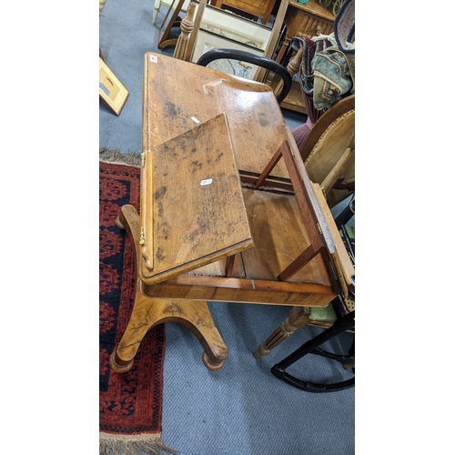 A Victorian walnut duet reading/music table having an octagonal column ...