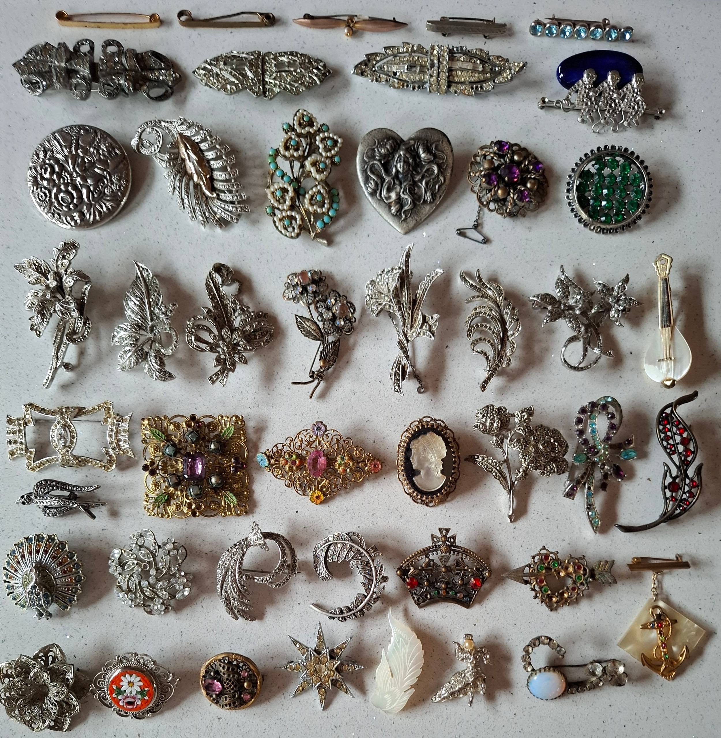 A collection of 20th Century brooches, mainly silver tone and marcasite ...