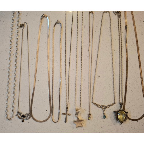 41 - A group of silver and white metal chains (minimum 50g), mixed pendants to include silver examples, s... 