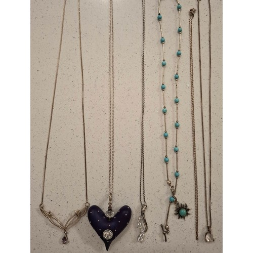 41 - A group of silver and white metal chains (minimum 50g), mixed pendants to include silver examples, s... 