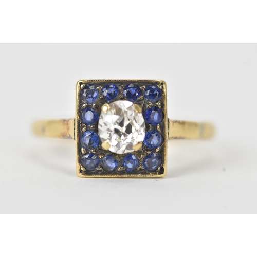 13 - A sapphire and diamond 18ct gold cluster ring, set with an oval old-cut diamond within a border of t... 