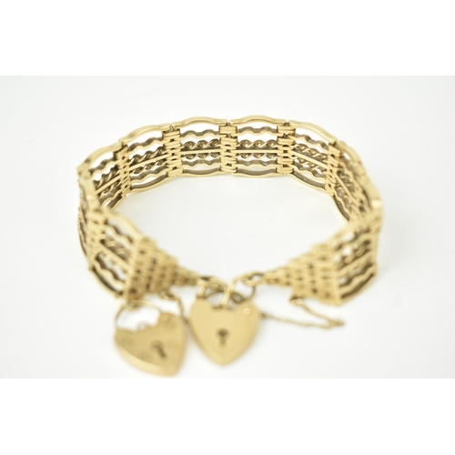 16 - A 9ct gold gate link bracelet, fitted with a heart shaped charm and a heart shaped padlock clasp, st... 
