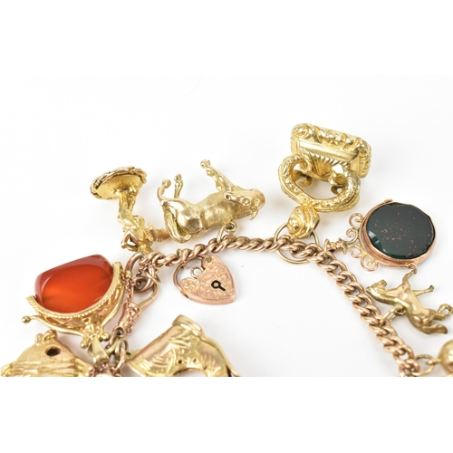 17 - A 9ct gold curb link charm bracelet, fitted with mixed charms to include fobs, teapot, boot, horse a... 