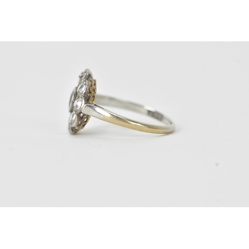 18 - A sapphire and diamond platinum cluster ring, the round-cut sapphire measuring approximately 4.3mm d... 