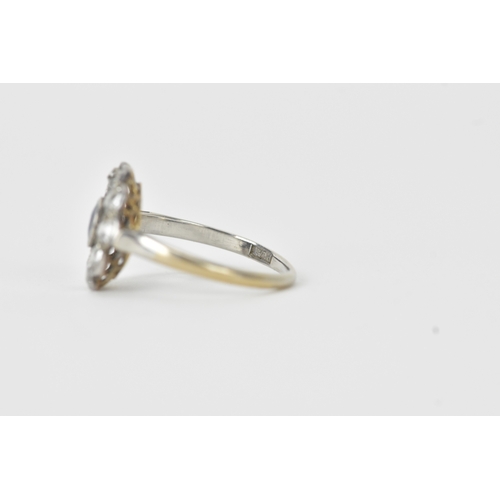 18 - A sapphire and diamond platinum cluster ring, the round-cut sapphire measuring approximately 4.3mm d... 