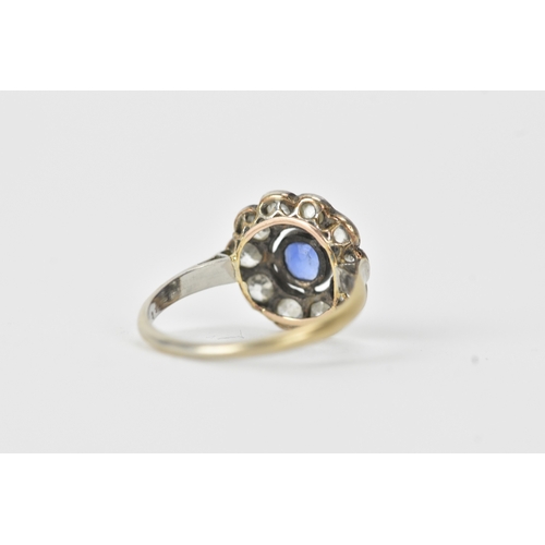 18 - A sapphire and diamond platinum cluster ring, the round-cut sapphire measuring approximately 4.3mm d... 