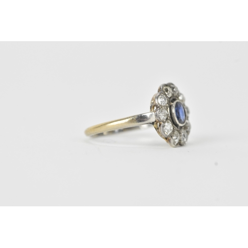18 - A sapphire and diamond platinum cluster ring, the round-cut sapphire measuring approximately 4.3mm d... 