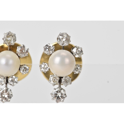 3 - A pair of pearl and diamond cluster earrings, each centred with a round pearl (possibly natural), me... 