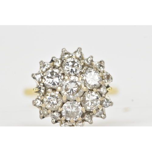 51 - A diamond 18ct gold cluster ring, the central brilliant-cut diamond measuring approximately 4.5mm di... 