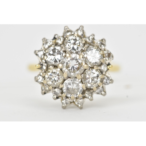 51 - A diamond 18ct gold cluster ring, the central brilliant-cut diamond measuring approximately 4.5mm di... 