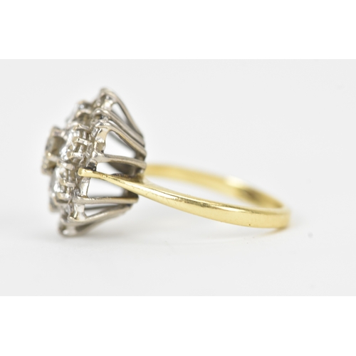 51 - A diamond 18ct gold cluster ring, the central brilliant-cut diamond measuring approximately 4.5mm di... 
