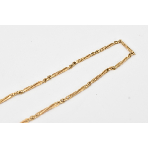 57 - A 9ct gold Albert pocket watch chain with fob, the chain formed of elongated engine-turned links, wi... 