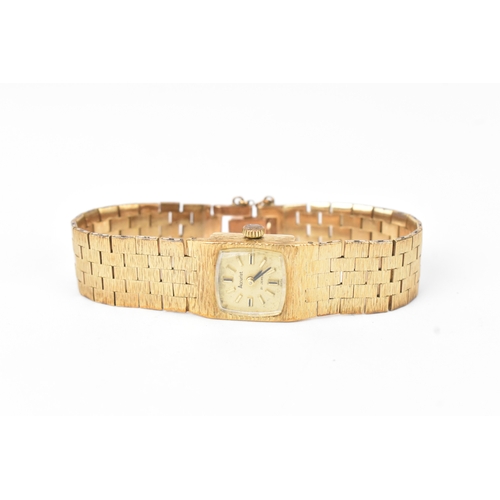 6 - An Accurist 9ct gold ladies manual wind wristwatch, the square dial having baton markers, on an arti... 
