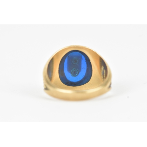60 - A 10ct gold Marymount London class ring, set with a blue synthetic panel centred by a relief school ... 