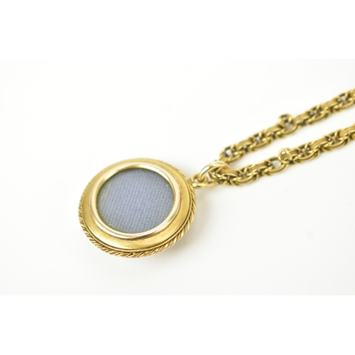 7 - A Victorian yellow metal Etruscan Revival mourning pendant and necklace, unmarked, the circular pend... 