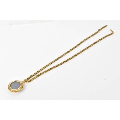 7 - A Victorian yellow metal Etruscan Revival mourning pendant and necklace, unmarked, the circular pend... 