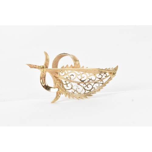 8 - A 9ct gold brooch in the form of a leaf, pierced with scroll work design, stamped 375, 58.2mm, 10.4 ... 