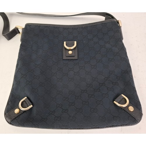 1 - Gucci- A 1990's GG black canvas Abbey D-Ring crossbody bag with black leather trim and shoulder stra... 