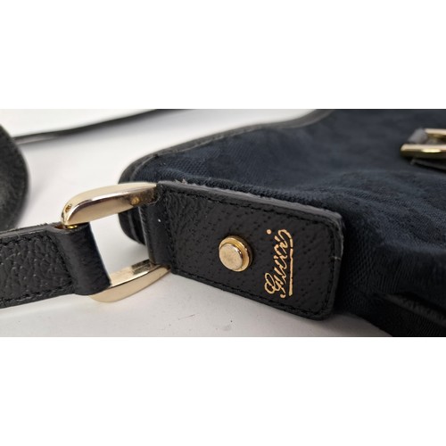 1 - Gucci- A 1990's GG black canvas Abbey D-Ring crossbody bag with black leather trim and shoulder stra... 