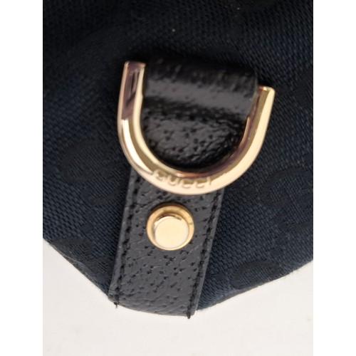 1 - Gucci- A 1990's GG black canvas Abbey D-Ring crossbody bag with black leather trim and shoulder stra... 