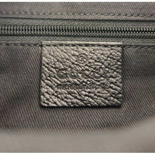 1 - Gucci- A 1990's GG black canvas Abbey D-Ring crossbody bag with black leather trim and shoulder stra... 