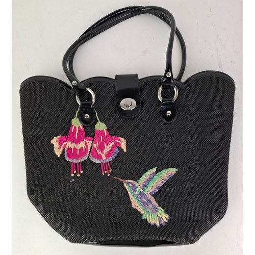 10 - Lulu Guiness- A black coated bag with rattan embroidered hummingbird and fuchsia design, 38cm wide x... 