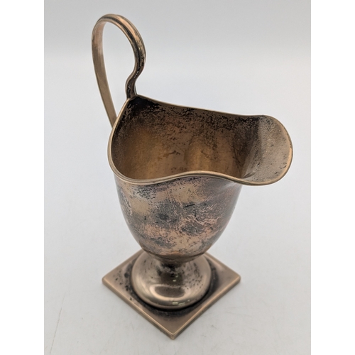28 - A silver helmet-shaped cream jug on a pedestal square base, 106.7g Location:P
If there is no conditi... 