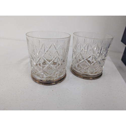 29 - A set of six crystal cut glass tumblers with silver rims hallmarked Birmingham 1980 housed in a fitt... 