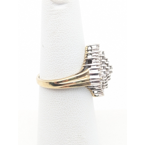 34 - A 9ct yellow gold diamond cluster ring set with 25 brilliant cut diamonds and 35 baguette cut diamon... 