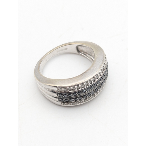 35 - A 9ct white gold diamond and black stone diamond cluster ring on a tapering shank, size N1/2, weight... 