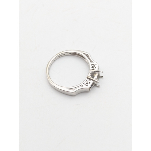 38 - A 9ct white gold ring set with two sapphires, central stone missing, weight 3.2g
Location:R1
If ther... 