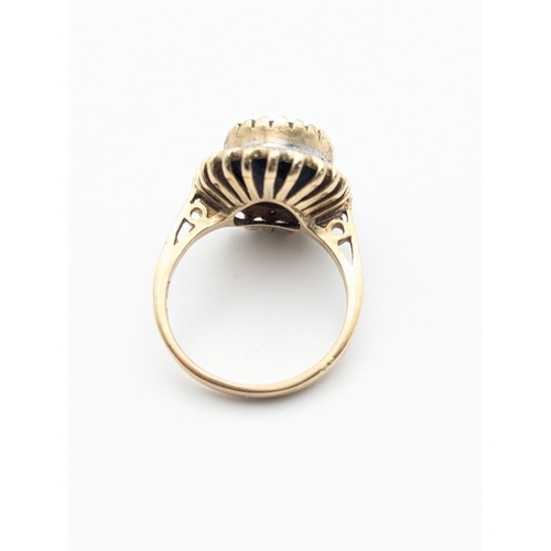 41 - A diamond and sapphire 9ct yellow and white gold cluster ring comprising of an oval cut claw set sap... 